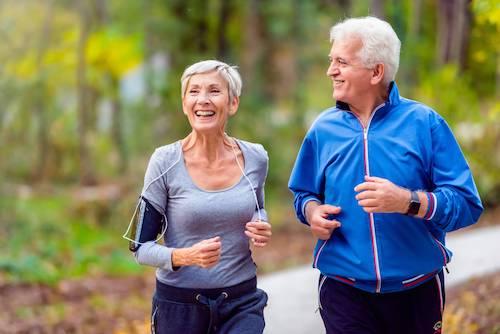 An older couple jogging in the park