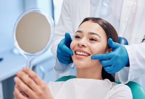 A patient examining her dental work
