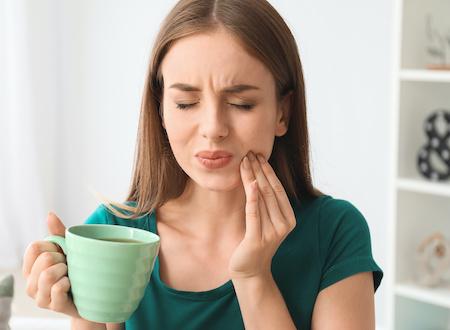 A woman with tooth pain | Tooth extraction Long Beach