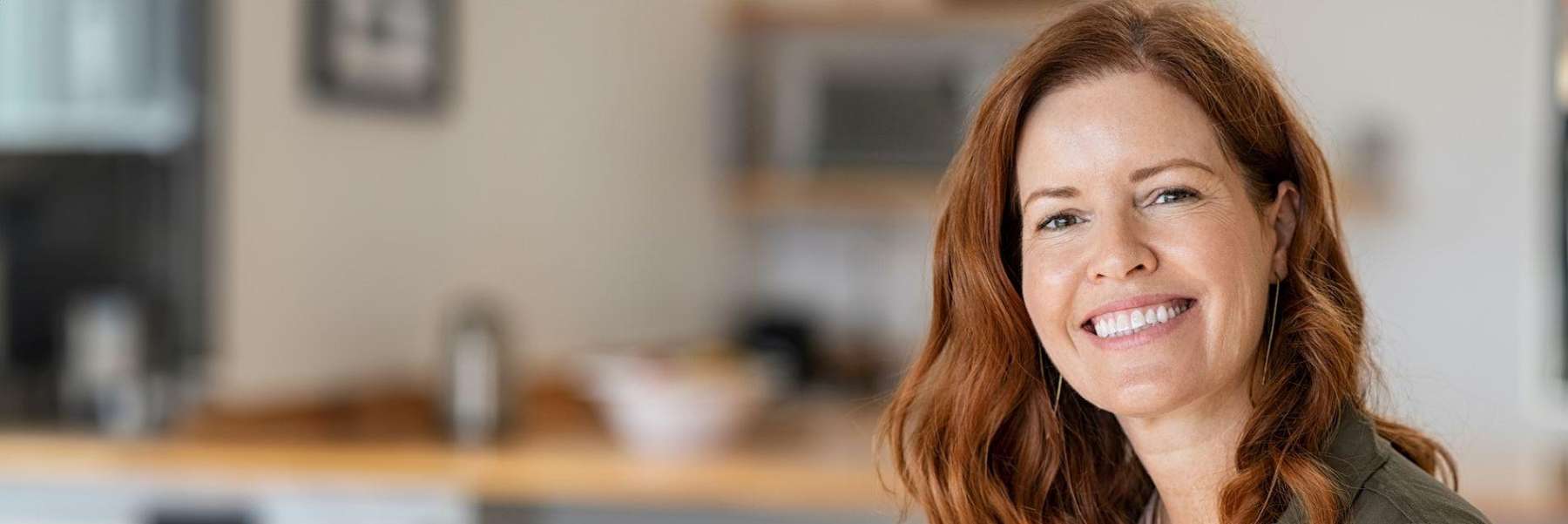 A smiling woman in her home | collagen production long beach ca