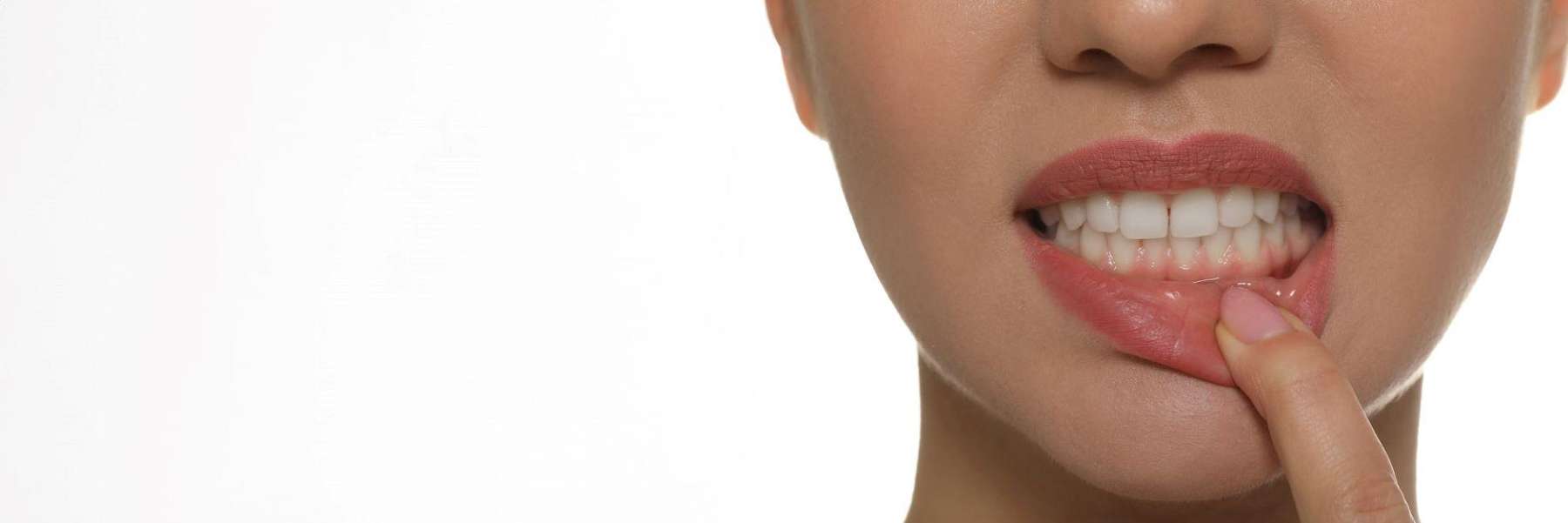 A woman showing her teeth | dentist Long Beach