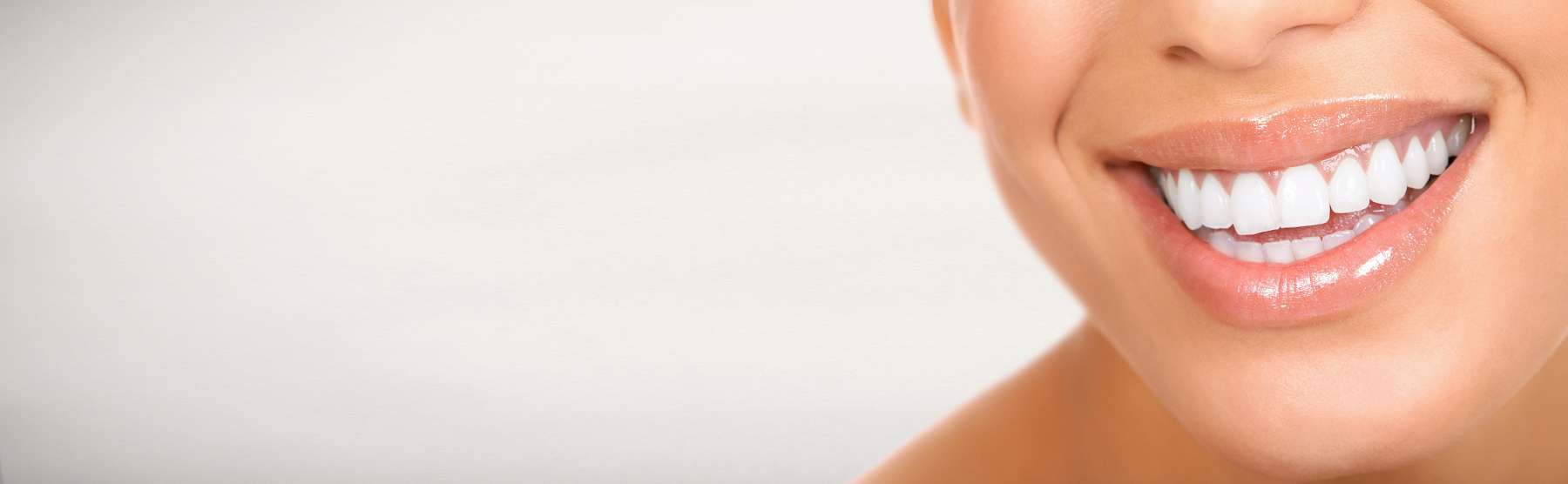 A smiling woman against a white background | oral hygiene Long Beach
