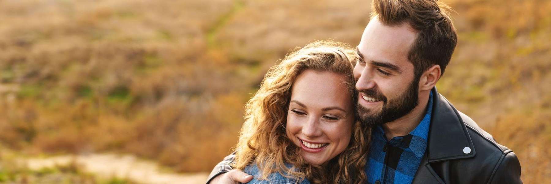 A smiling couple in the park | dentist Long Beach CA