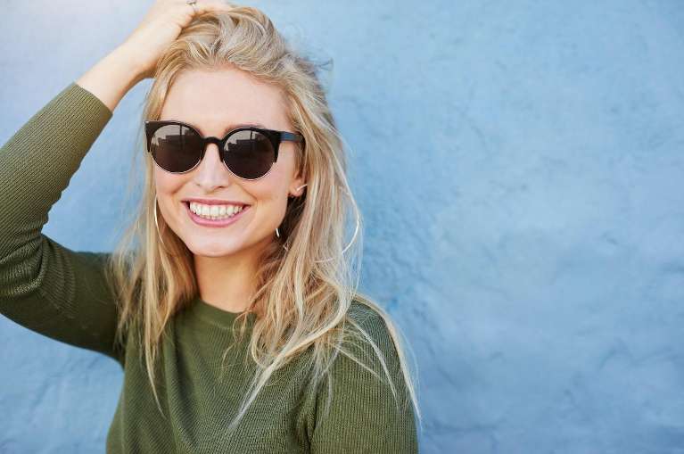 A woman with sunglasses smiling