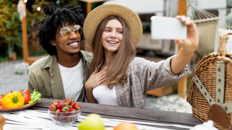 A smiling couple taking a selfie | dental crowns long beach