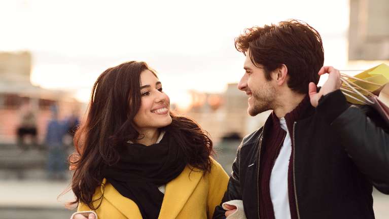 A smiling couple shopping | dentist Long Beach