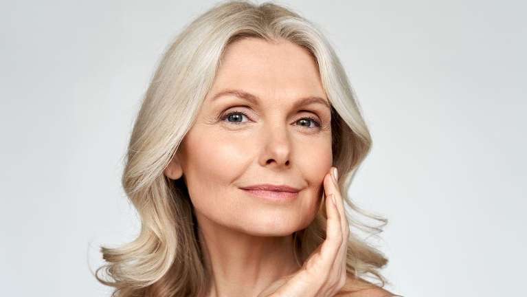 A smiling older woman | dental implants Long Beach CA
