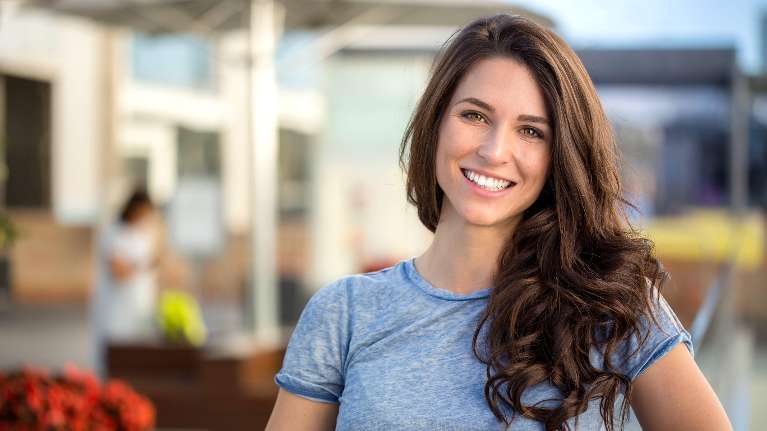 A smiling woman on a patio