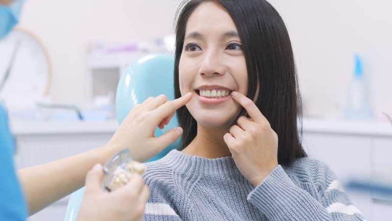 A woman having a conversation with her dentist | oral infection Long Beach