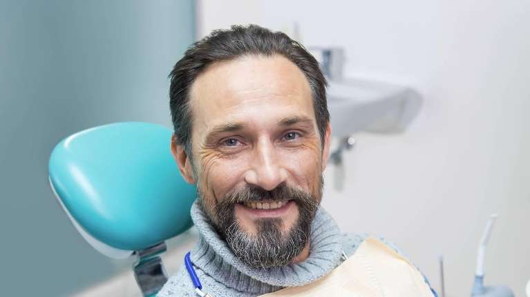A smiling man in the dentist's chair | dentist in long beach