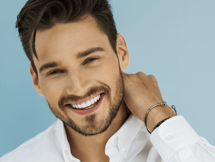 A smiling man with white teeth | same day crowns Long Beach