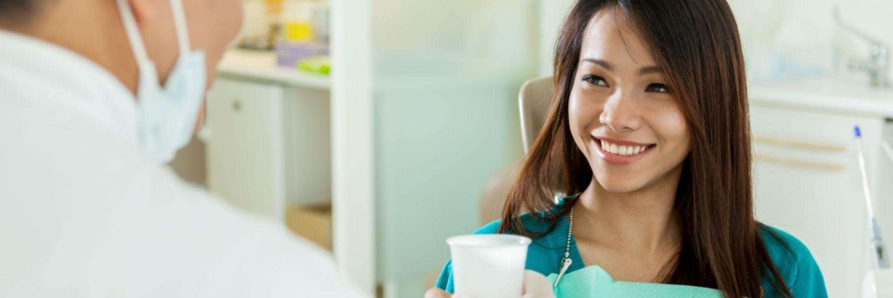 A smiling woman getting a dental exam